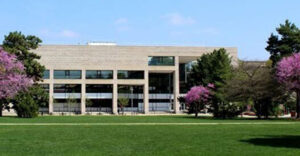 Parks library building on campus in the Spring with blossoming trees